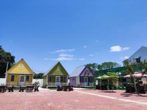 a group of colorful houses on a brick road at Zing Motel in Butterworth