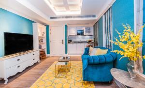 a living room with blue walls and a blue couch at Hotel Madera Hollywood in Hong Kong