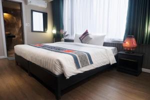 Postel nebo postele na pokoji v ubytování Swan Sapa Hotel