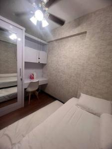 a bedroom with a bed and a desk with a chair at Apt Casablanca East 2BR With Netflix and Pool in Jakarta