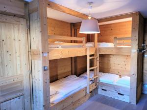 a bunk room with four bunk beds in it at Confortable T4, terrasse, parking et Wi-Fi, au centre et proche pistes - FR-1-598-129 in Les Gets