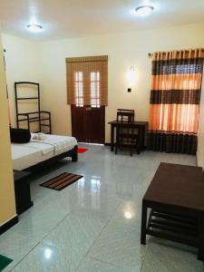 a living room with a bed and a table at Aurora View Inn in Haputale +94 photos