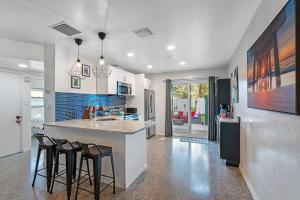 a kitchen with a counter and some stools in it at Upscale 2br House Wprivate Yard & Parking in St Petersburg