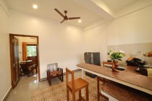 a living room with a ceiling fan and a table at Le Pondy Home Stay in Pondicherry