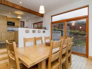 a kitchen and dining room with a wooden table and chairs at Seascape in Fiskavaig