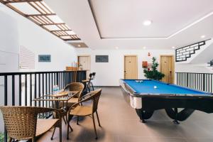a billiard room with a pool table and chairs at La Maison De Fleurs in Da Nang