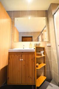 a bathroom with a sink and a mirror at Good Day Hostel in Bangkok