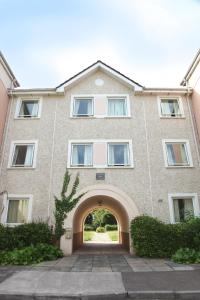 a large brick building with an entry way at Castlewhite Apartments - UCC Summer Beds in Cork