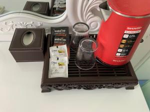 a shelf with two glasses and a blender on it at Hotel MAI TUAN Chánh Môn A in Tây Ninh