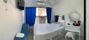 a small bedroom with a bed and a mirror at Hotel MAI TUAN Chánh Môn A in Tây Ninh