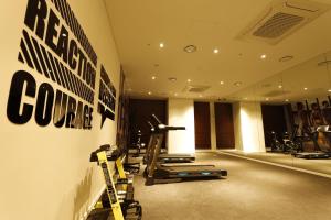 a gym with treadmills and exercise equipment on a wall at Best Western Plus Jeonju in Jeonju