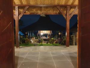 an open door to a patio at night at Villa Pondok Dauh Saba in Tabanan