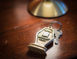 a key chain on a table next to a lamp at Hotel Mozart in Vienna