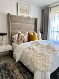 a bedroom with a white bed with a furry blanket at M Luxury Home In Irene Centurion-No Blackouts in Centurion