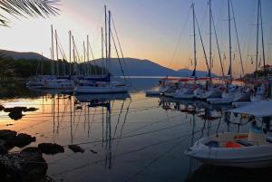 a group of boats are docked in a harbor at Faros Suites (Adults Only) in Fiskardo