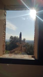 a window with a view of a rock formation at Villa Pieve Vecchia in Campagnatico