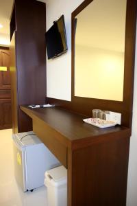 a bathroom with a counter with a sink and a mirror at Sunshine Hostel in Hua Hin