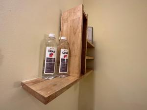 two bottles of water on a wooden shelf on a wall at Upar Hotels Indiranagar in Bangalore
