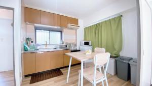 a kitchen with a table and chairs in a room at Esperanza 204号室 in Tokyo
