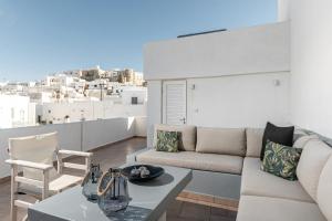 a living room with a couch and a table at Cozy Comfy Town House in Naxos Chora