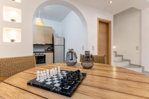 a chess board on a wooden table in a kitchen at Cozy Comfy Town House in Naxos Chora +39 photos