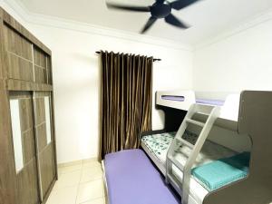 a small room with a bunk bed and a ceiling fan at SK Homestay Seremban 2 in Seremban