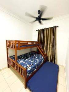 a bedroom with a bunk bed with a ceiling fan at SK Homestay Seremban 2 in Seremban