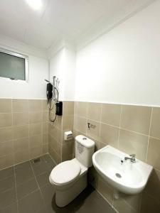 a bathroom with a toilet and a sink at SK Homestay Seremban 2 in Seremban +8 photos
