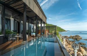 a rendering of a hotel with a view of the ocean at InterContinental Danang Sun Peninsula Resort by IHG in Danang +196 photos