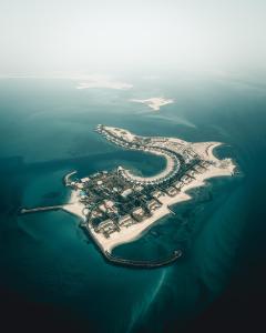 an aerial view of an island in the ocean at Nurai Island, Saadiyat in Abu Dhabi