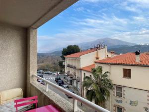 a balcony with a view of a street and buildings at Appartement T3 climatisé,balcon, classé 3 étoiles in Le Boulou