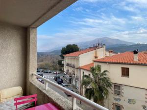 a balcony with a view of a street and buildings at Appartement T3 climatisé,balcon in Le Boulou