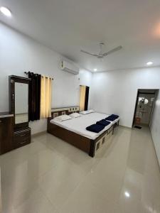 a bedroom with a large bed and a mirror at iIRA Stays: Ocean Bliss (Sea View) in Alibaug