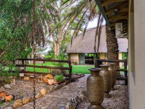 a group of vases sitting outside of a house at Progress Guest Farm 