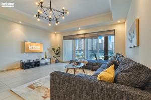 a living room with two couches and a tv at bnbmehomes - Great Value over looking Canal in Professional Apt - 303 in Dubai