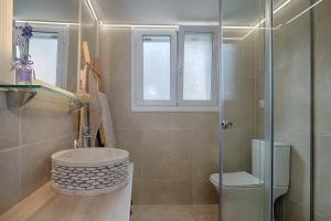 a bathroom with a shower and a sink and a toilet at Luxury Ap.Tennis in Ágios Rókkos +21 photos