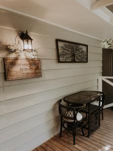 a table and a chair on a porch at Misty Mountain Retreat in Olinda