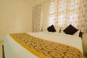 a bedroom with a large white bed in a room at Hotel Cheelgadi in Jaipur