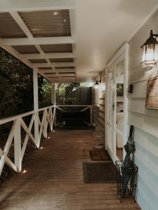 a porch of a house with a light on it at Misty Mountain Retreat in Olinda