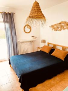 a bedroom with a large bed with a blue blanket at BINIALMESC in Alaior +45 photos