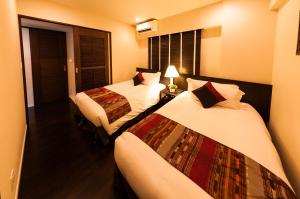 恩納的住宿－卡夫度假富著公寓酒店，酒店客房设有两张床和窗户。