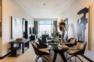 a dining room with a glass table and chairs at Amani Luxury Apartments Nairobi in Nairobi