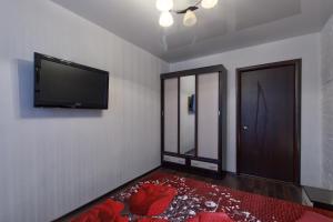a room with a flat screen tv and a door at EvroApartment on Moskovskaya in Saint Petersburg