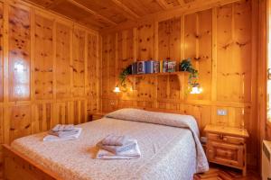 a bedroom with a bed in a wooden room at New apartment in Bormio - Centrale 20 in Piatta