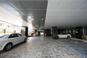 two white cars parked in a parking lot at Dasi 2 in Daejeon