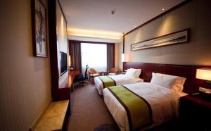 a hotel room with two beds and a television at Atour Hotel Wangfujing Ave Xinjiekou Nanjing in Nanjing