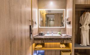 a bathroom with a sink and a mirror at Atour Hotel Guangzhou Jiangtai Road Station in Guangzhou