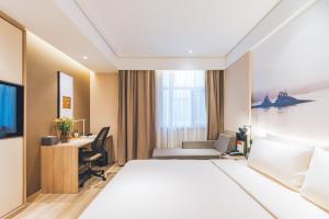 a hotel room with a bed and a desk at Atour Hotel Shanghai New International Expo Center Maglev Station in Shanghai