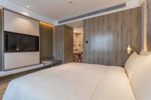 Postel nebo postele na pokoji v ubytování Atour Hotel Changsha IFC Center