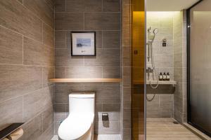 a bathroom with a toilet and a shower at Atour Hotel Chengdu Taikoo Li Future Center in Chengdu